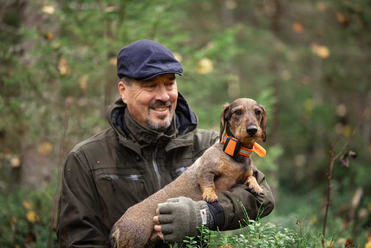 man holding dob in his arms